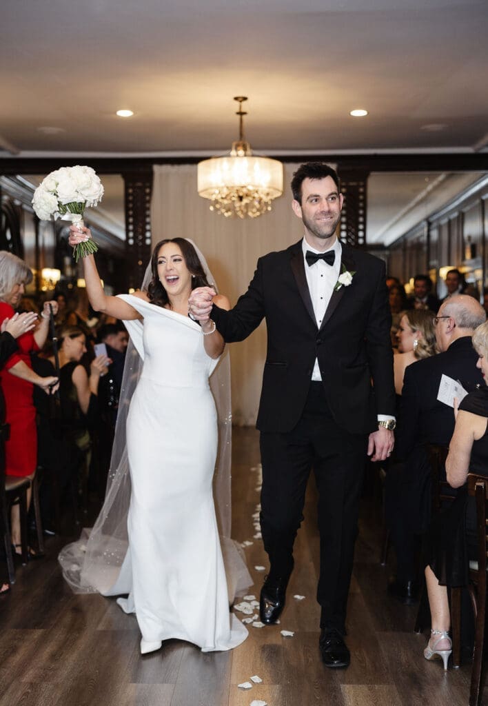 Bride and groom hand in hand