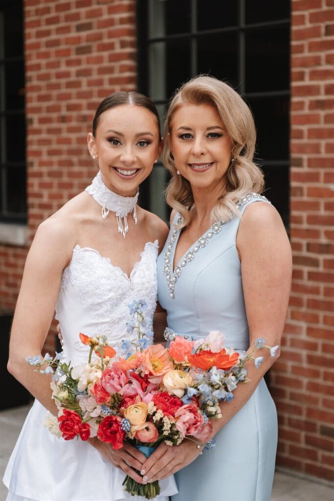Bride with her mom posing for photograph