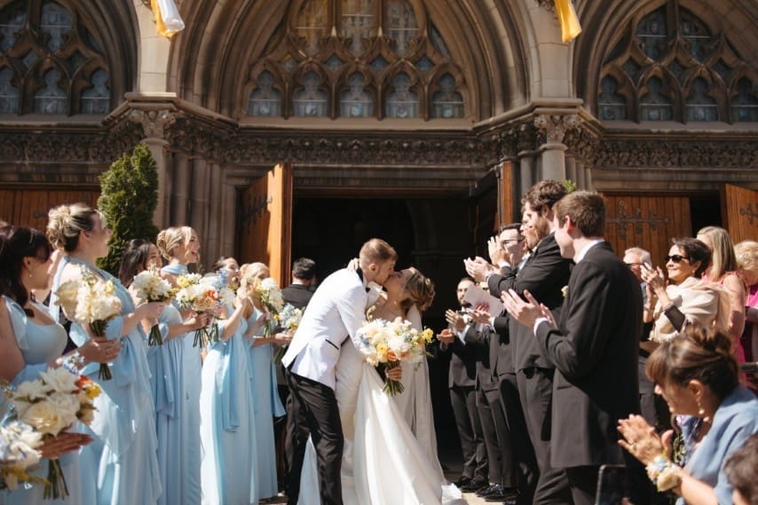 Bride and Groom kissing outside the church.