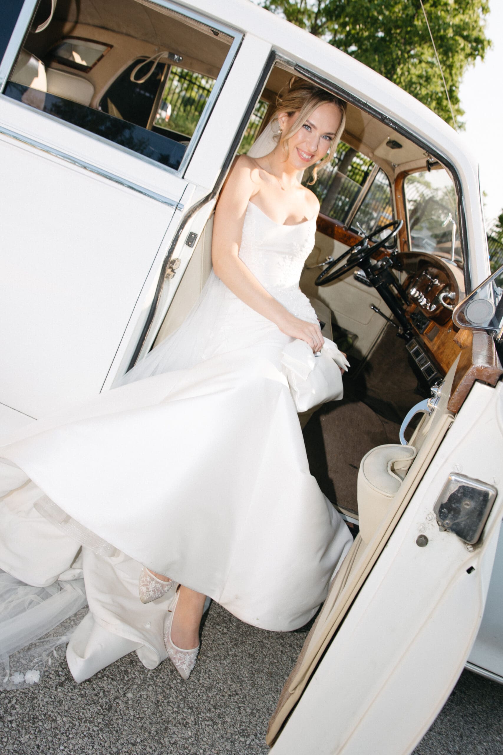 Bride sitting inside the car.