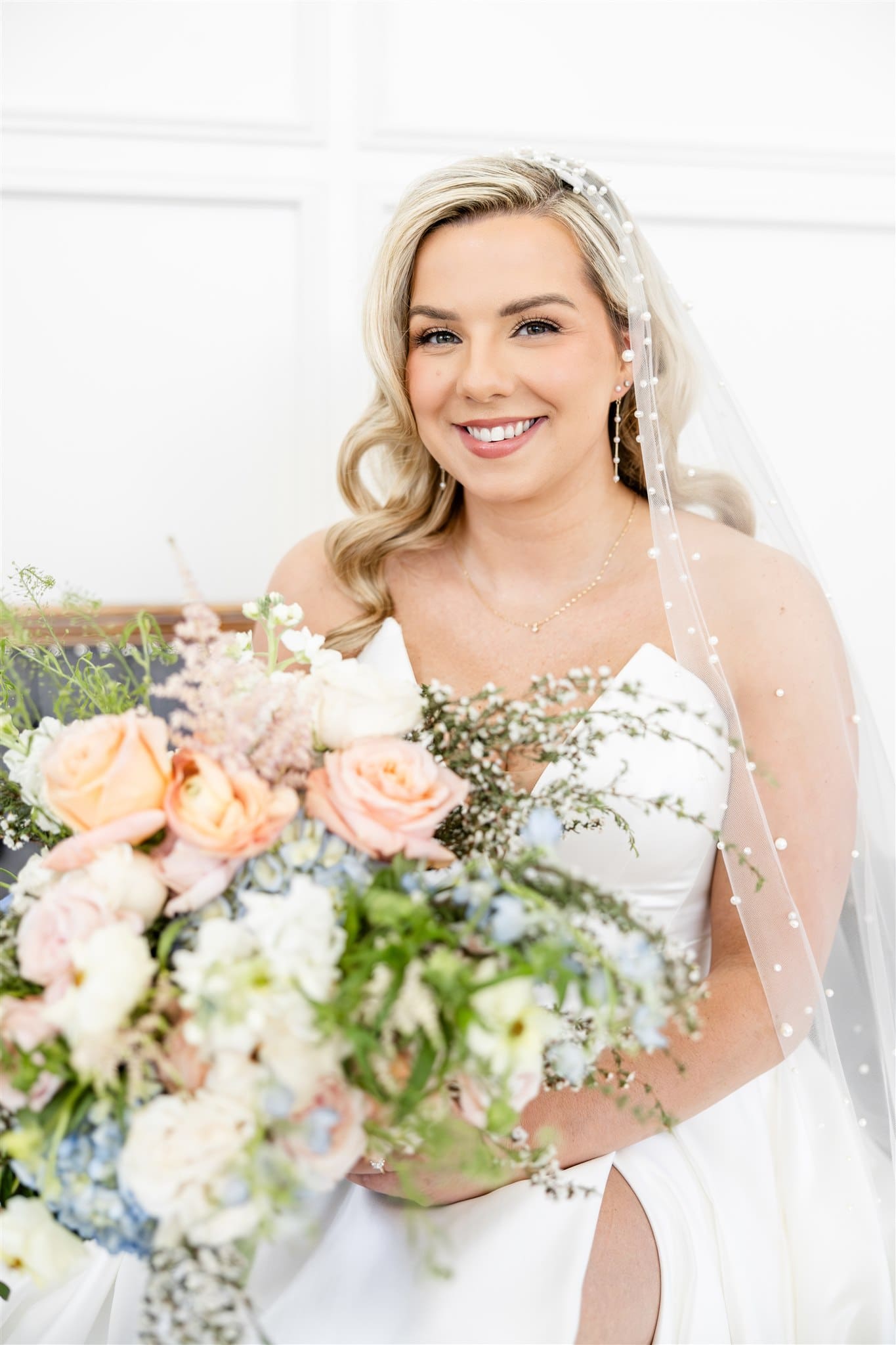 Bride sitting down holding her bouquet