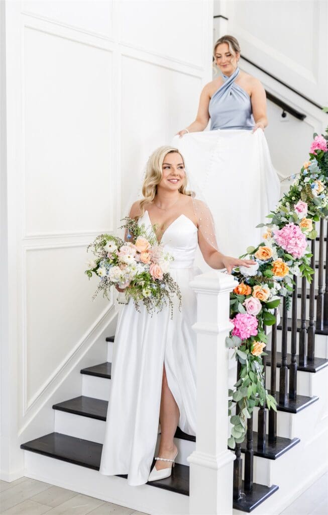 Bride with her bridesmaid walking down the stairs