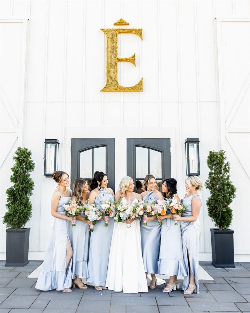 Bride with her bridesmaids holding bouquet of flowers