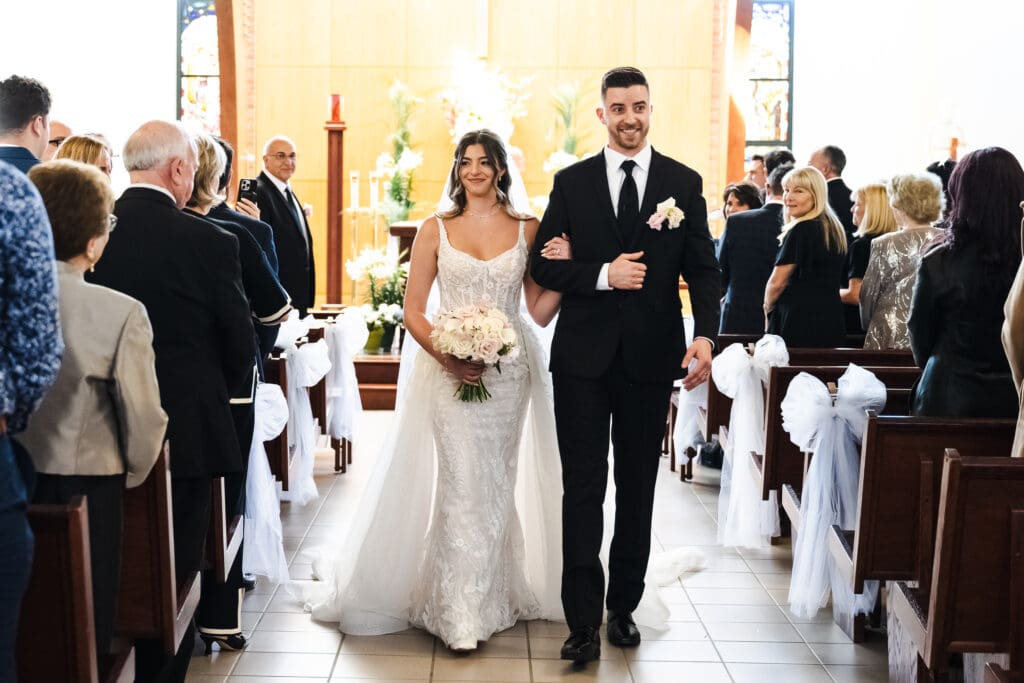Bride and groom walking down the aisle.
