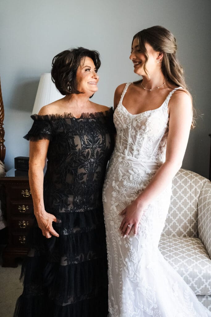 Bride and bride's mom posing for a picture.