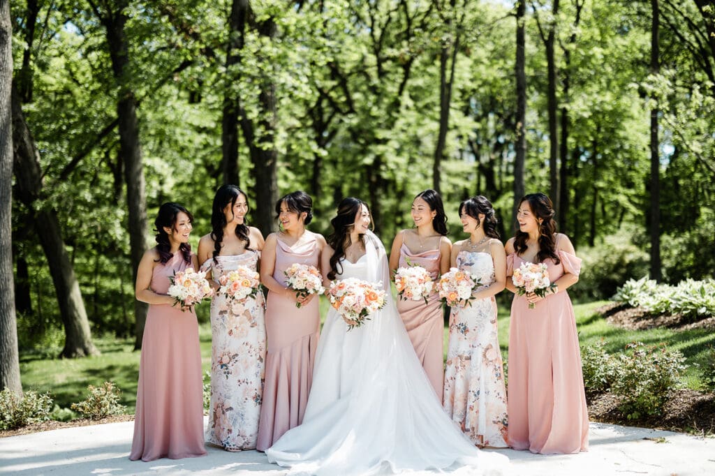 Bride poses for camera with her entourage bridesmaids