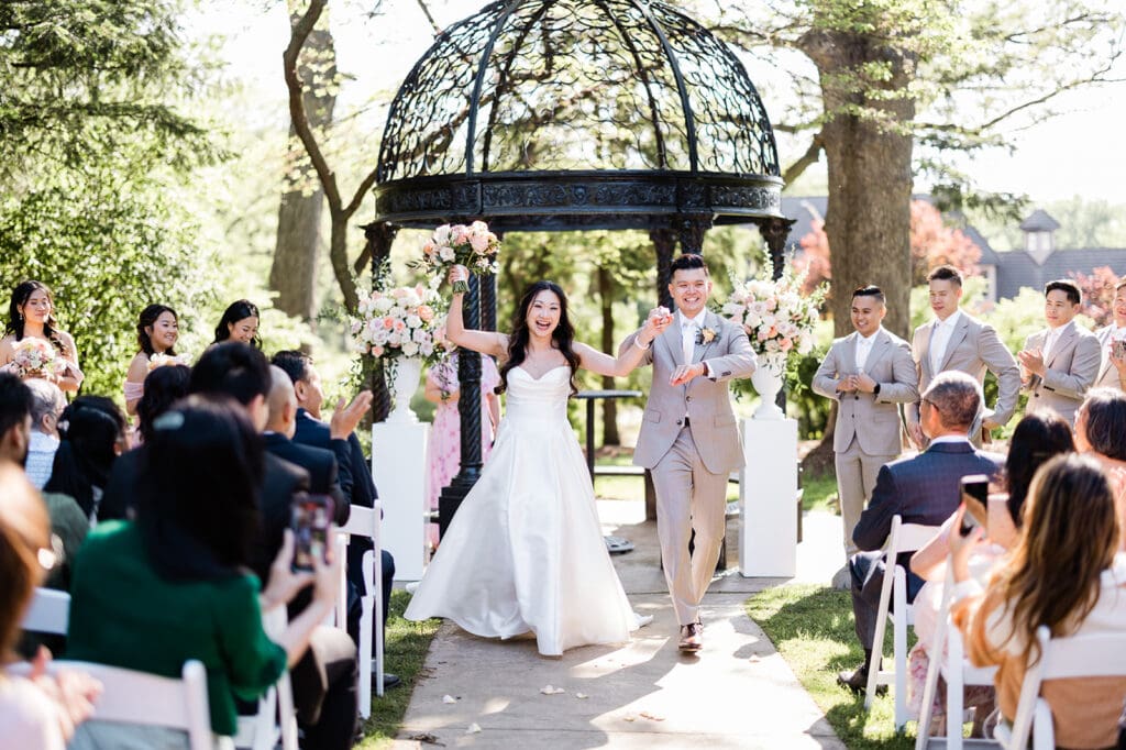 East Asian bride and groom walking in the aisle