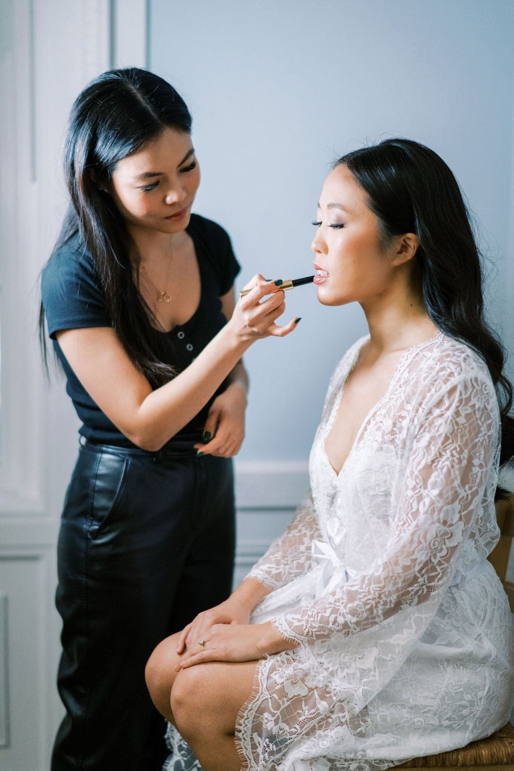 Makeup artist doing makeup on the bride