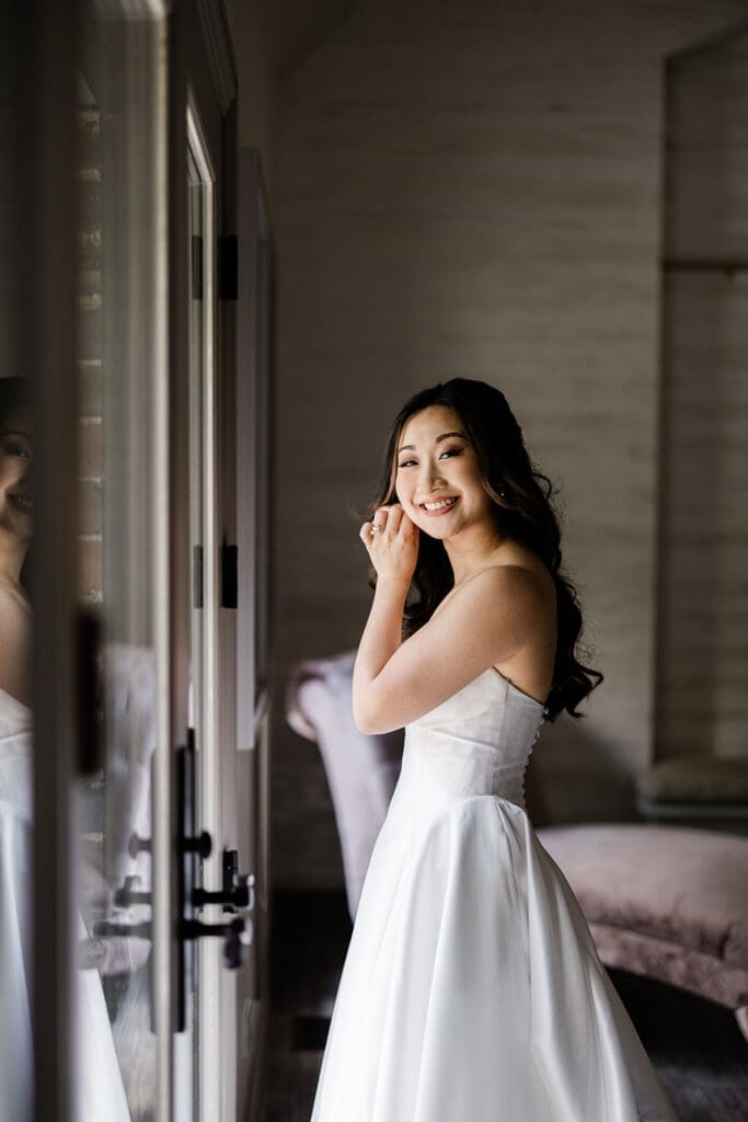 East Asian bride poses for camera