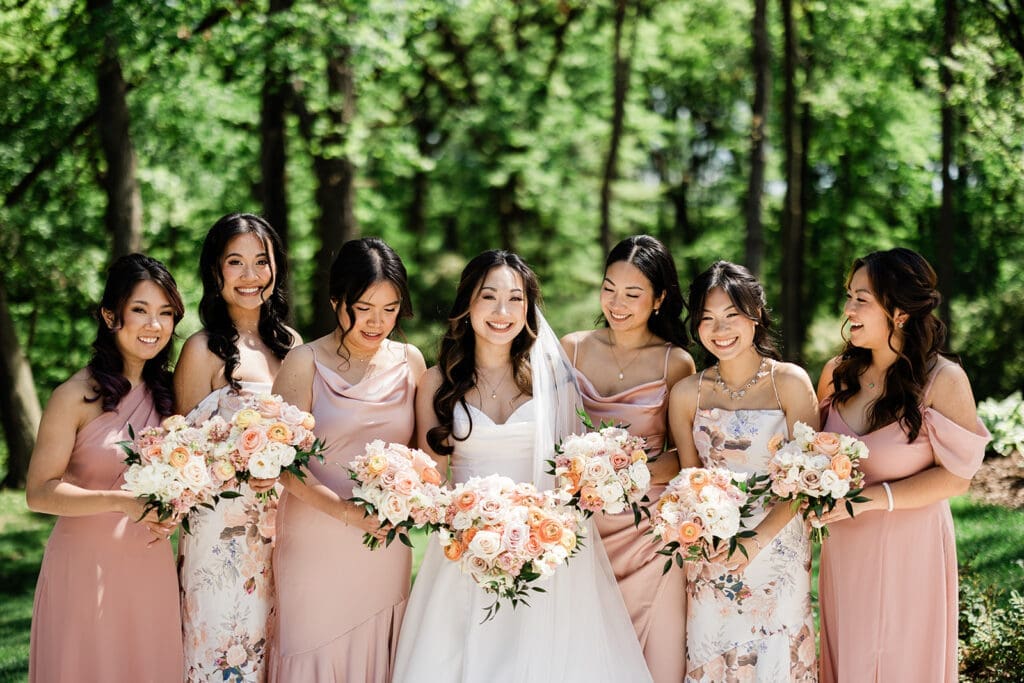 East Asian bride poses for camera with her entourage bridesmaids