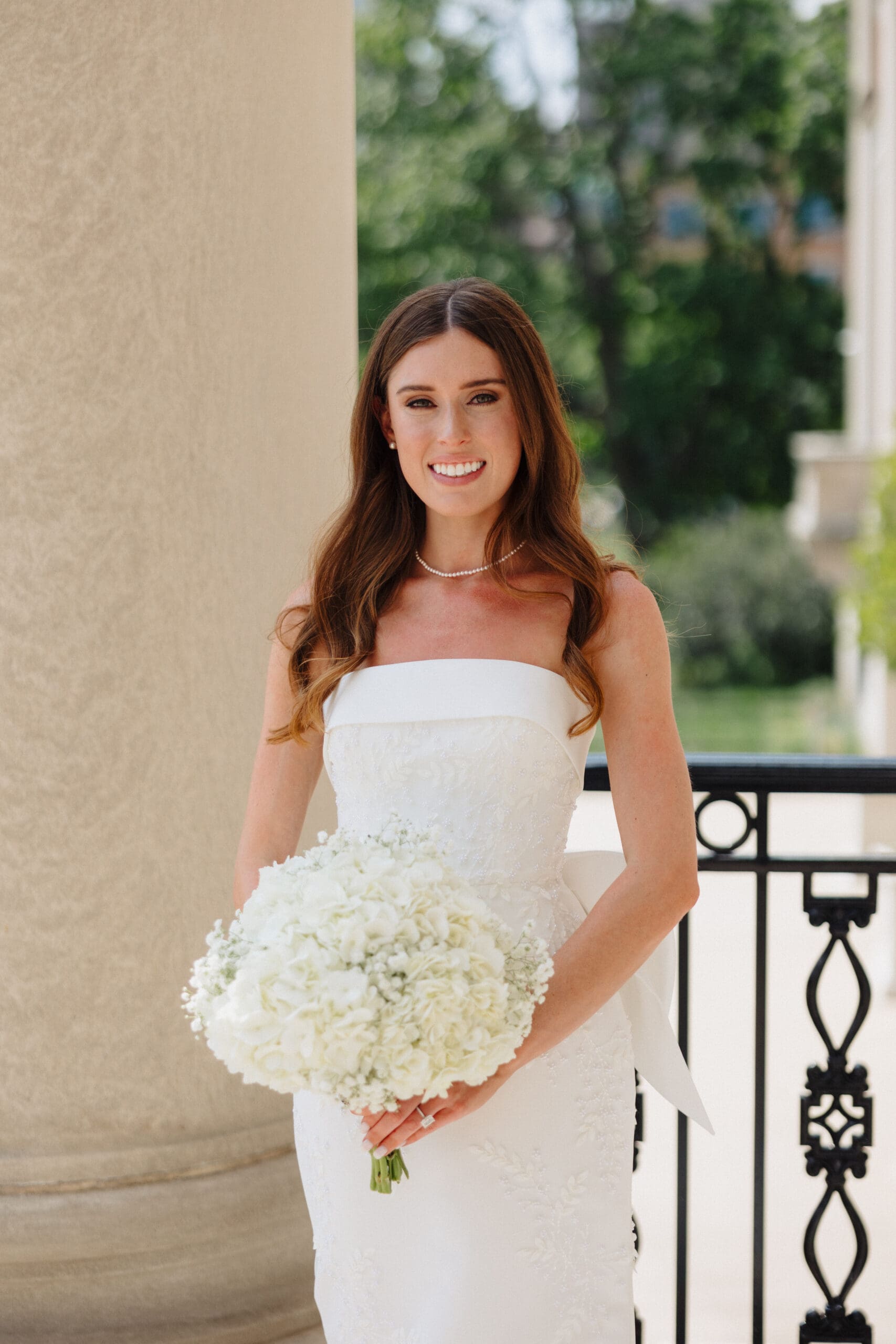 Bride standing holding a bouquet of flowers.