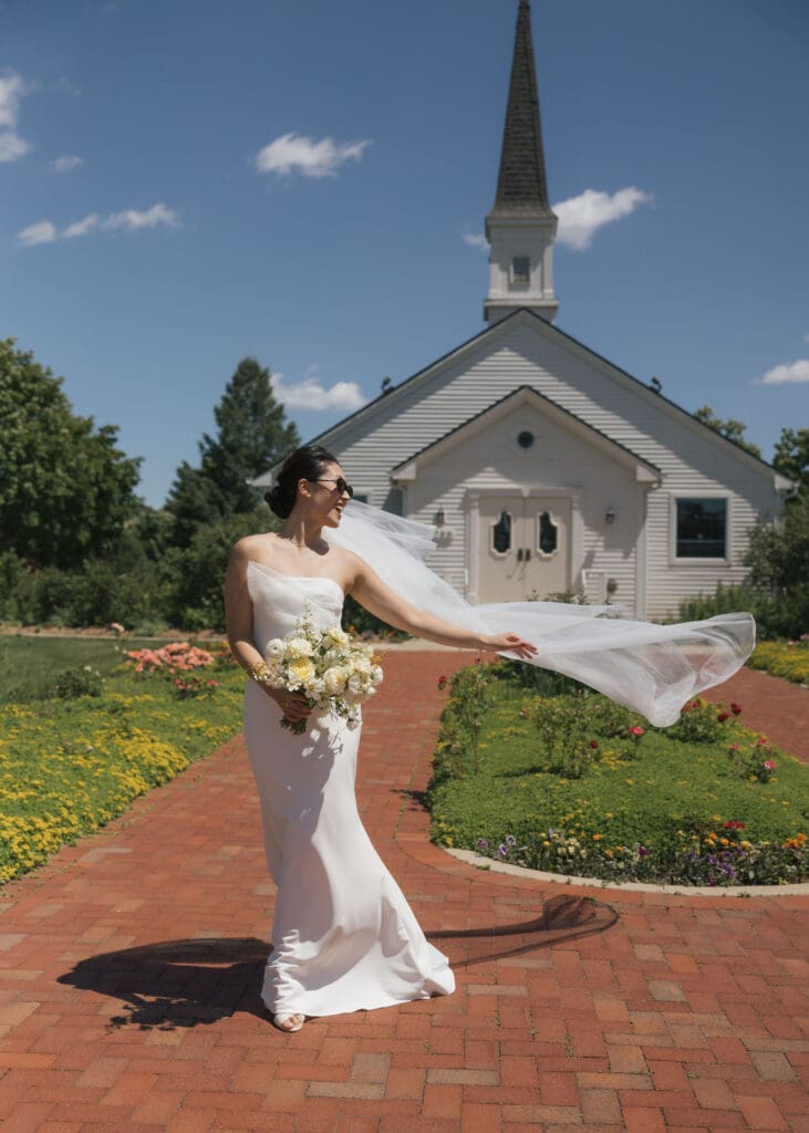 Asian bride holding a bouquet posing for the camera.