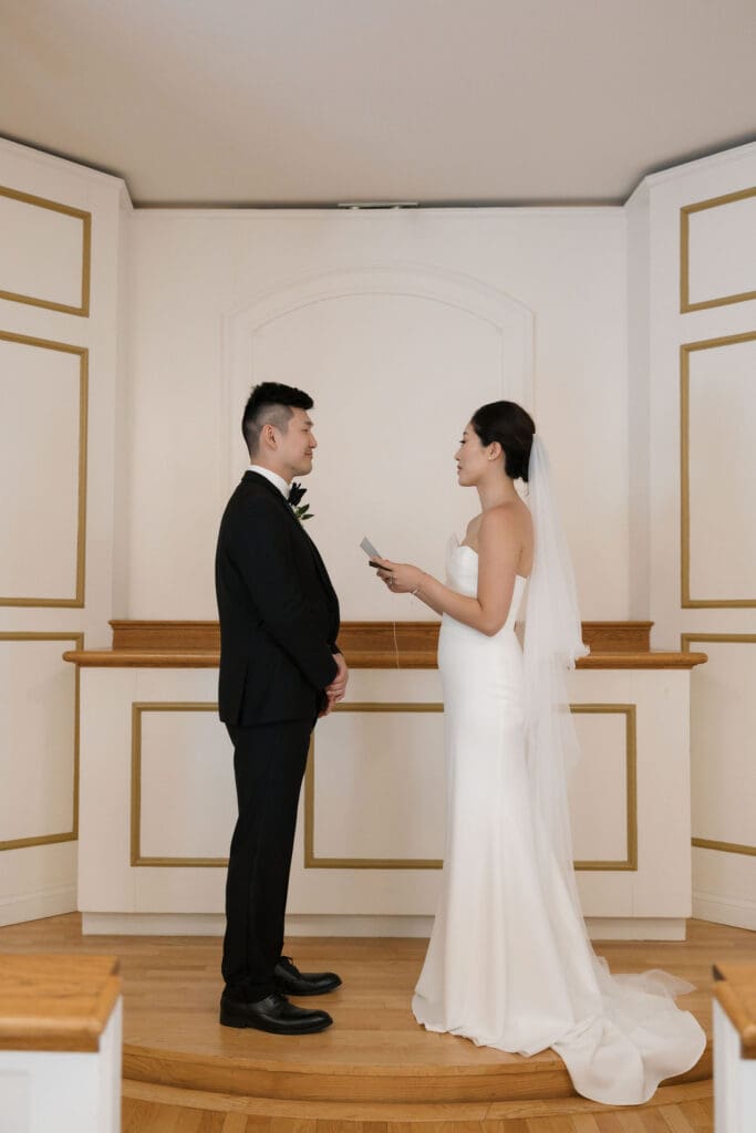 Asian bride and groom saying their vows on the altar.