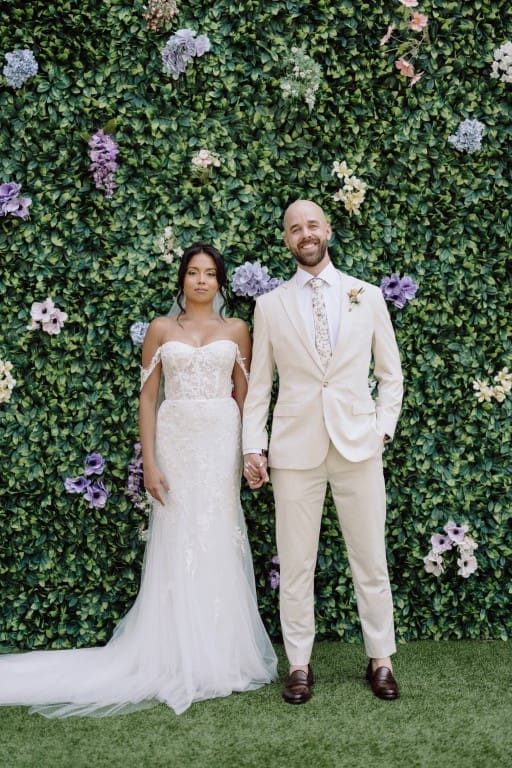Bride and groom smiling while holding hands.