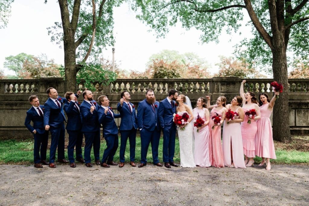 Bride and groom with their entourage posing.