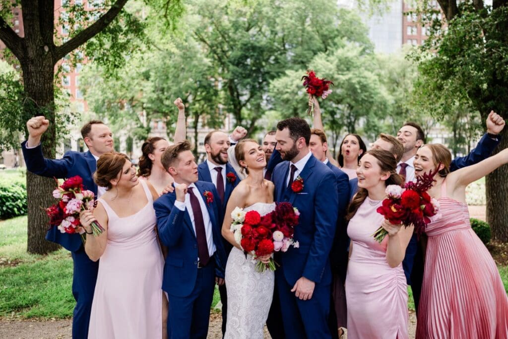 Bride and groom with their entourage posing.