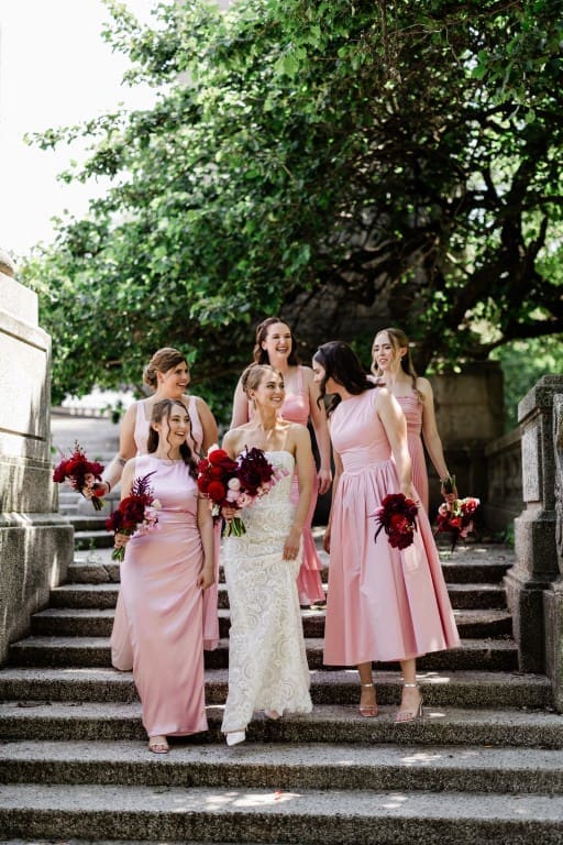 Bride and her bridesmaids holding a bouquet.