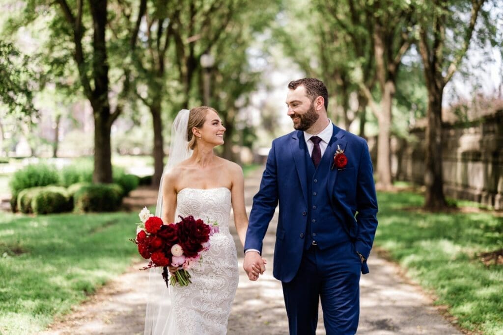 Bride and groom holding hands.
