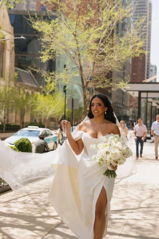 Bride wearing wedding gown and holding a bouquet.
