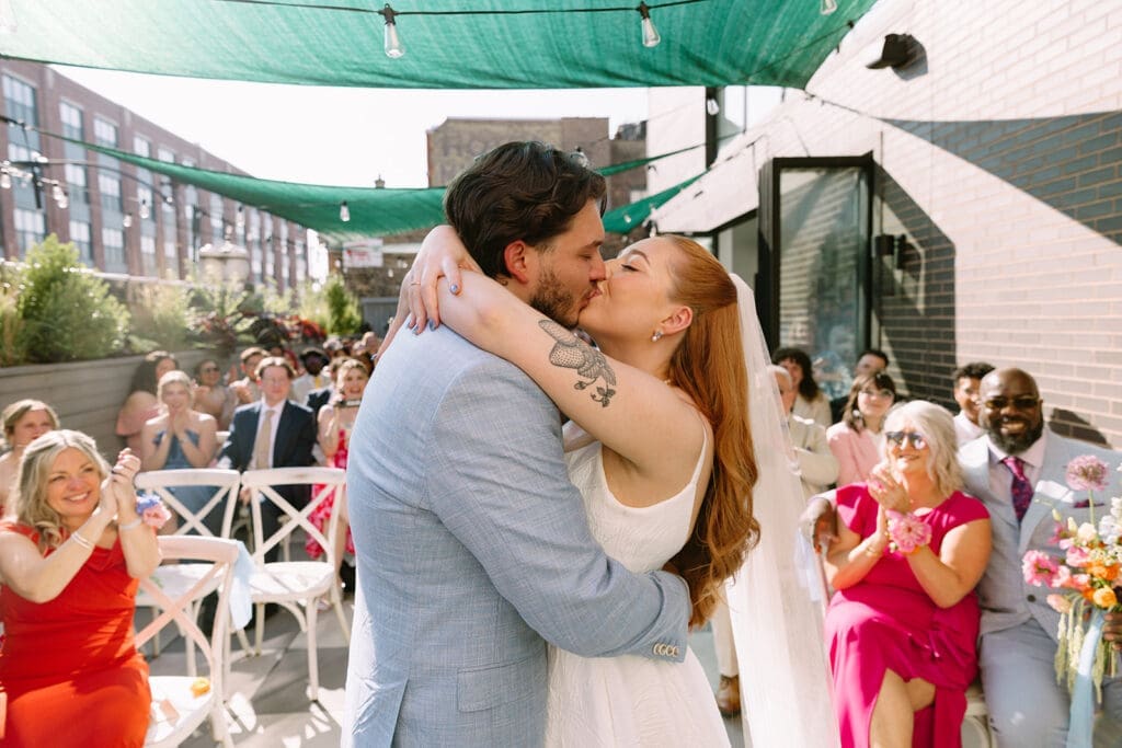 Bride and groom sharing a kiss on their wedding day.