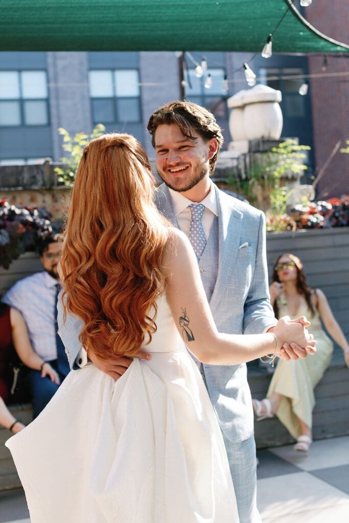 Happy bride and groom smiling together as they walk down the aisle.