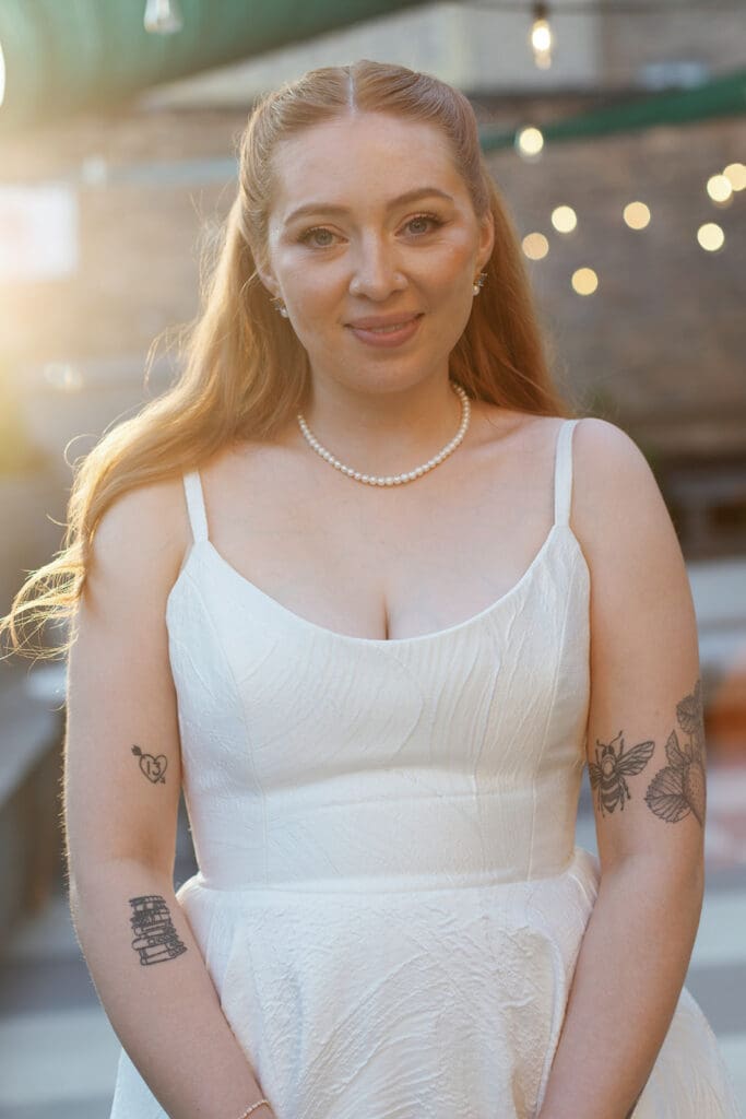 Bride smiling while wearing a beautiful white wedding gown.