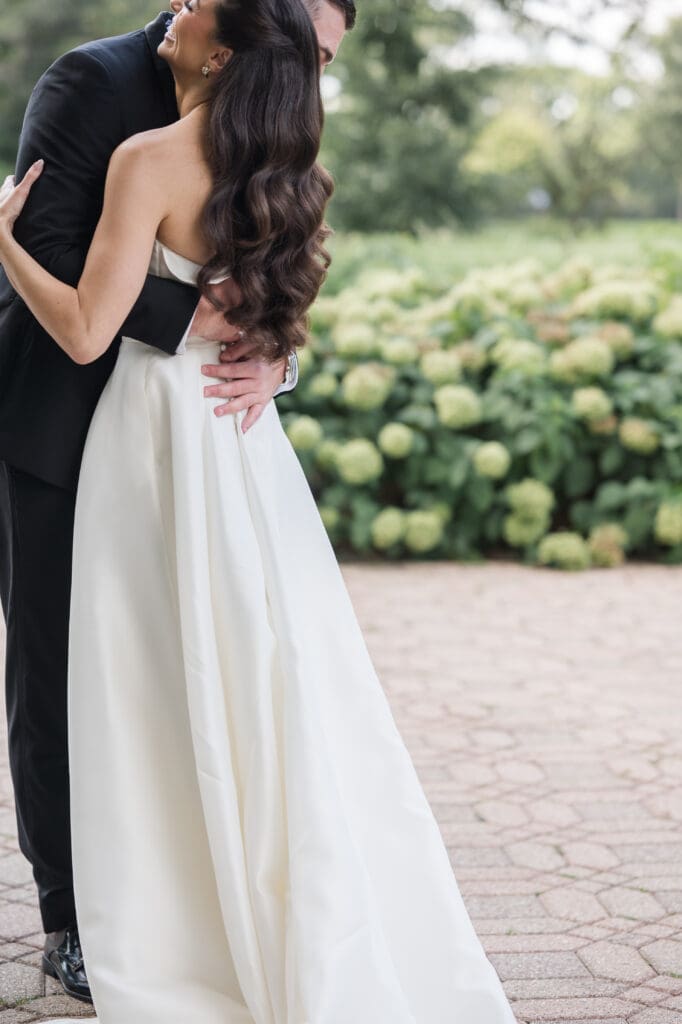 Bride and groom hugging.