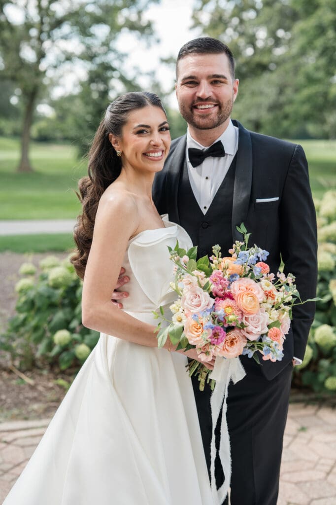 Bride and groom smiling on their wedding day.