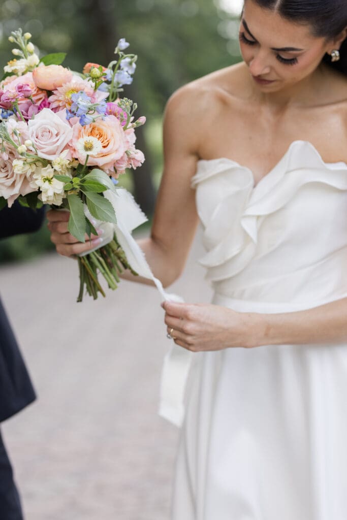 Bride holding her bouquet in a candid shot.