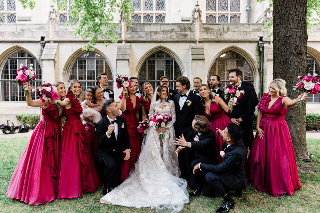 Bride and groom surrounded by their friends, posing together outdoors, capturing pre-wedding excitement.