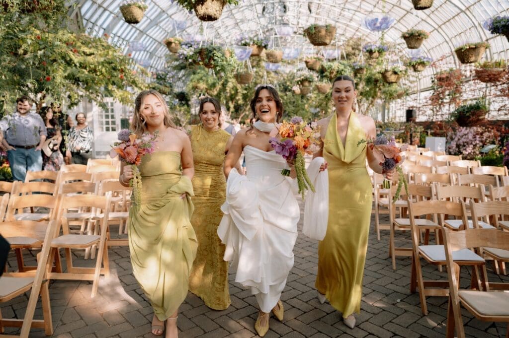 Chicago bride holding a bouquet smiling with her bridesmaids