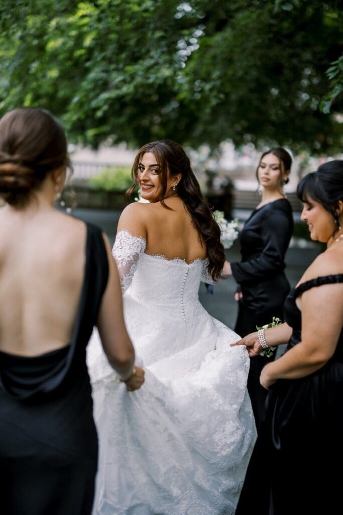 Chicago bride and her bridesmaids posing in classic bridal gown with soft glam makeup