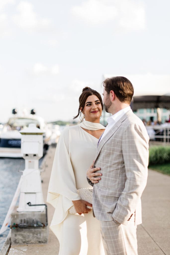 Chicago bride in soft glam makeup and elegant updo smiling with groom