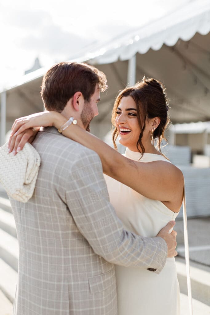 Bride with elegant updo hairstyle smiling with groom during Chicago wedding ceremony