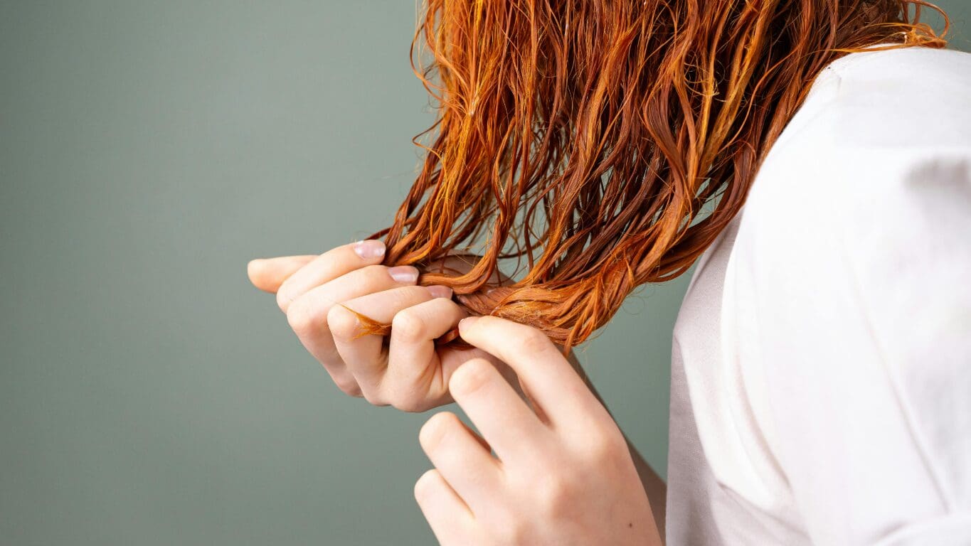 Woman conditioning the tips of her hair