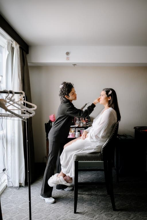 Bride getting hair and makeup