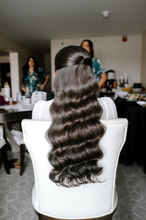 Chciago bride wearing a half up half down glam waves hairstyle