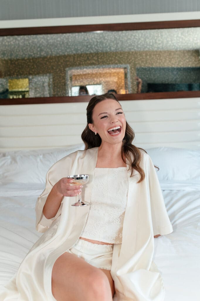 Bride smiling and holding a wine glass