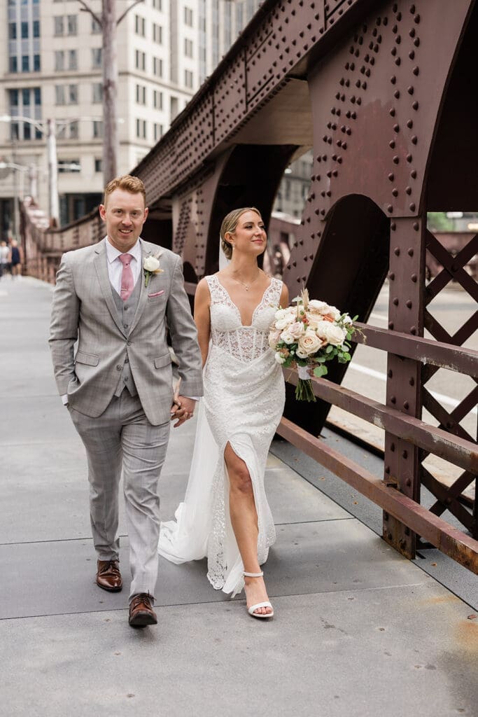 Chicago bride and groom walking behind a bridge