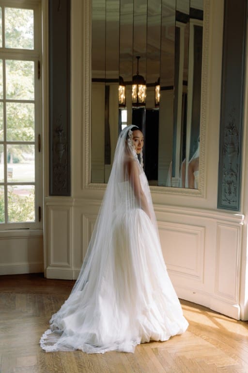 Asian bride in soft glam wearing veil