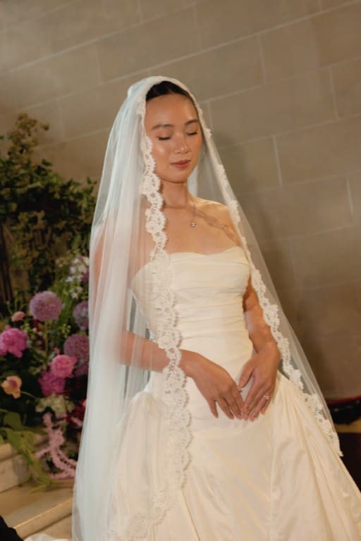 Asian bride in soft glam wearing veil