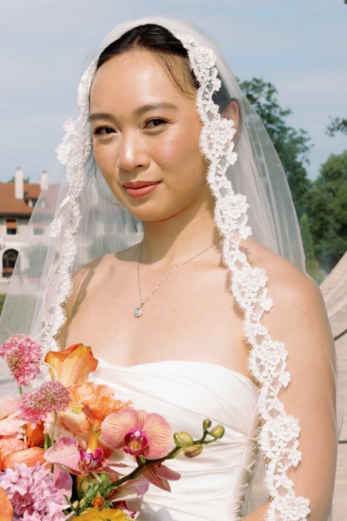 Asian bride in soft glam wearing veil