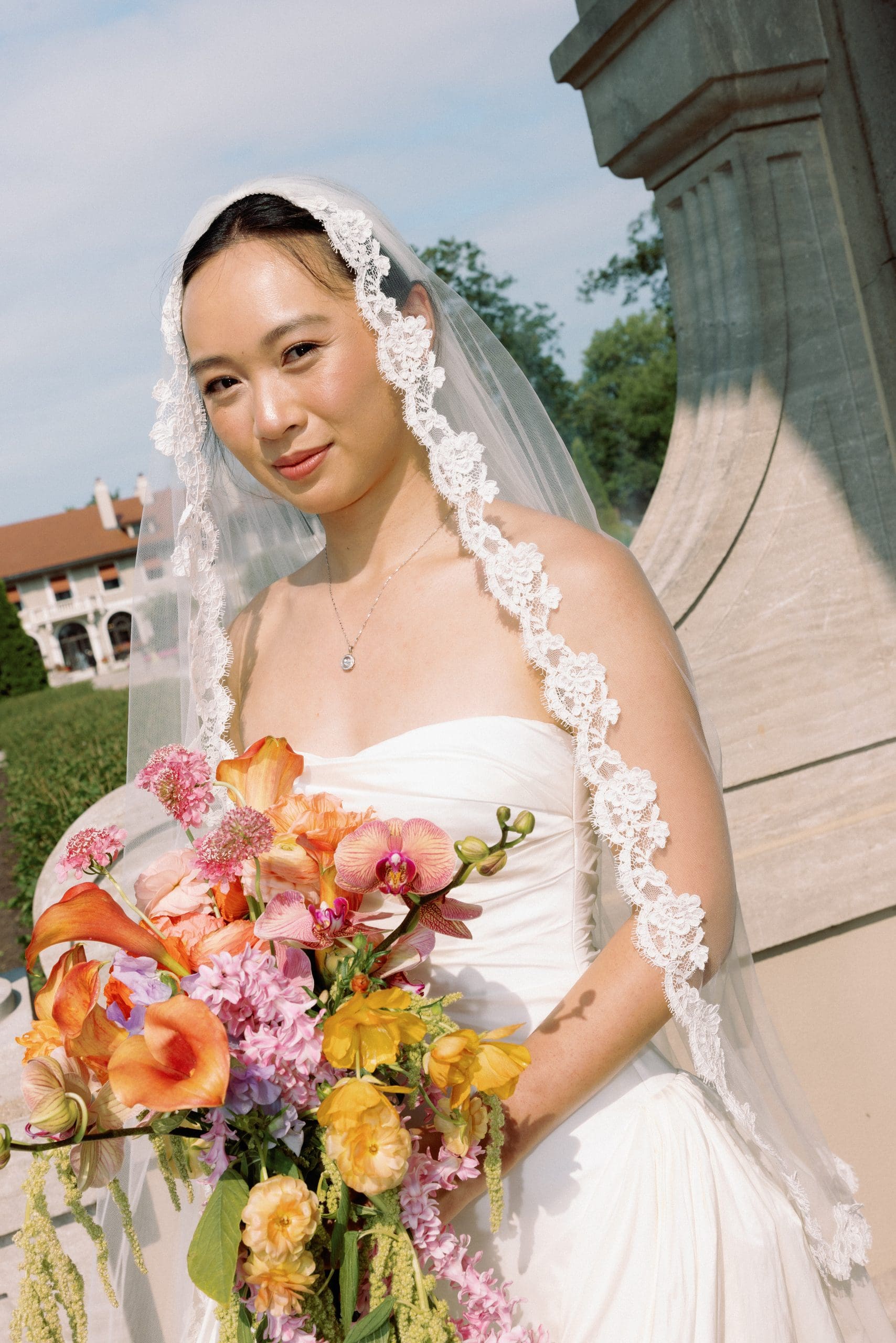 Asian bride in soft glam wearing veil