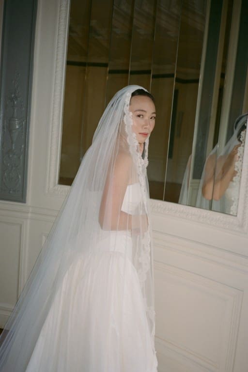 Asian bride in soft glam wearing veil